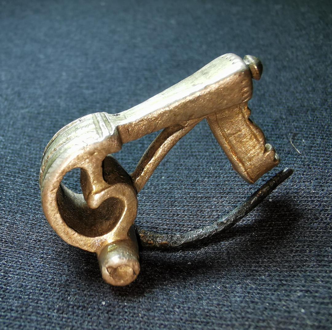 F5. A nice silver knee fibula: probably military